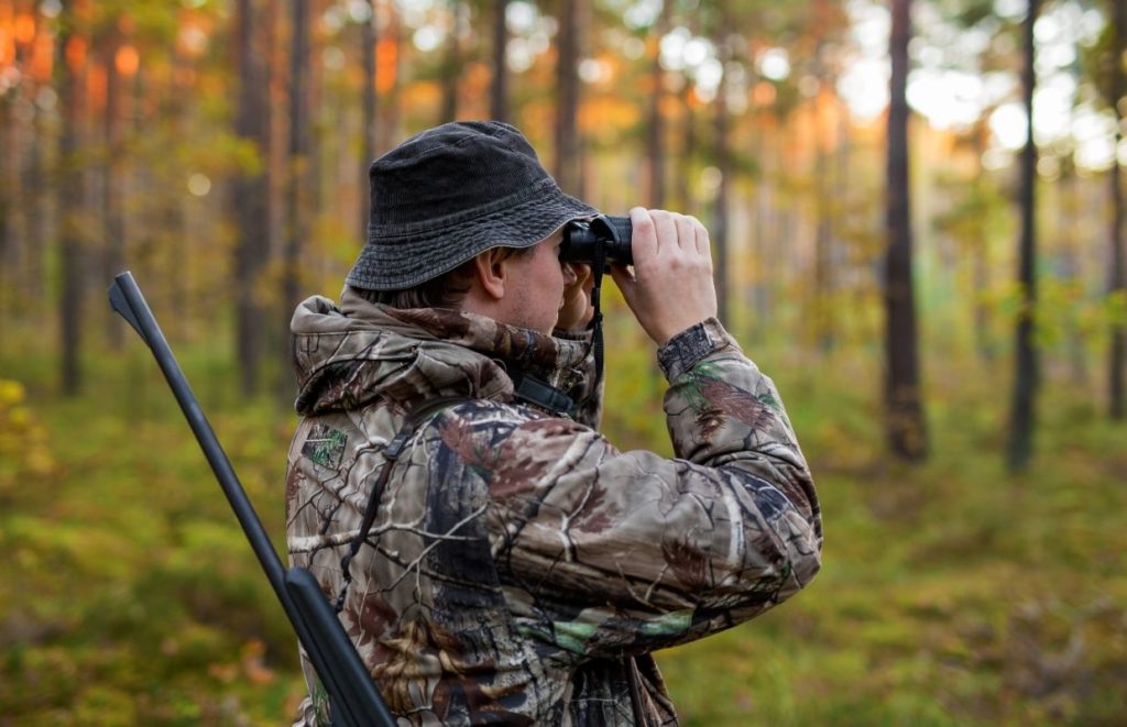 A man wearing his Best Wool Hunting Jacket while spotting his next shot
