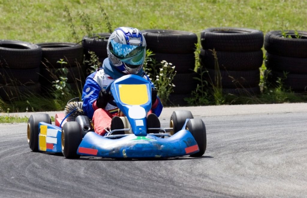 A man go-karting wearing the best karting helmet