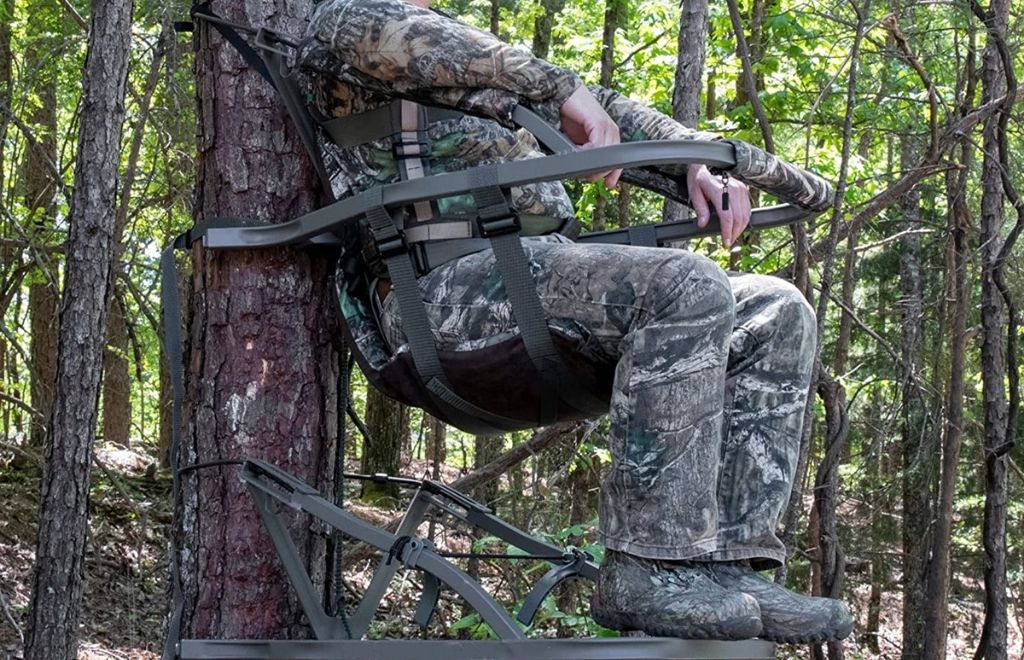 A hunter sits on a summit viper treestand with comfortably