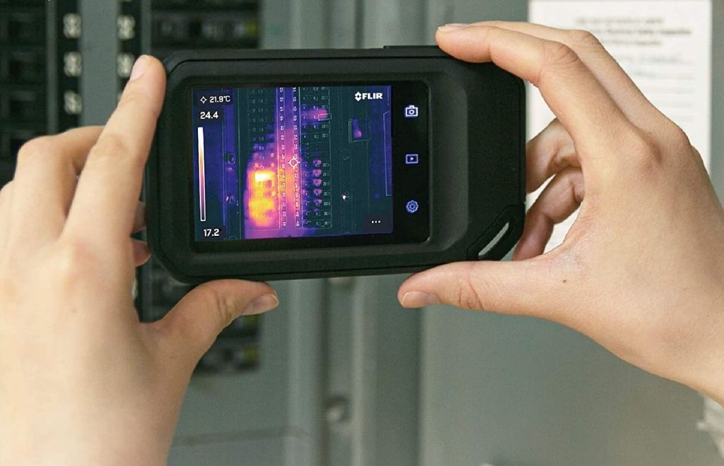 A man checking the temperature with thermal imaging cameras