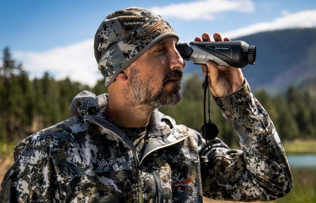 Hunter is looking for prey with a thermal monocular