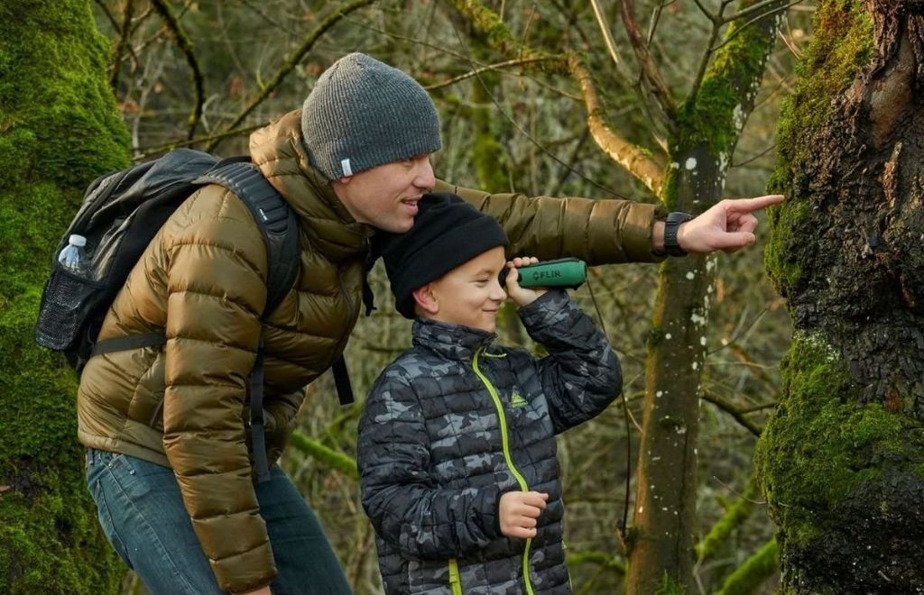 A man comes to the forest with his child to hunt