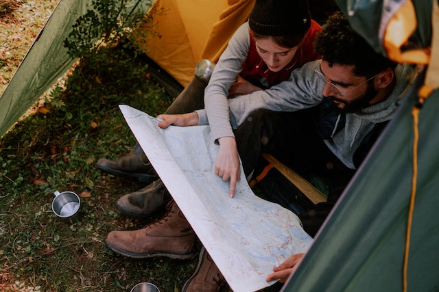 couple setting up camping in the woods