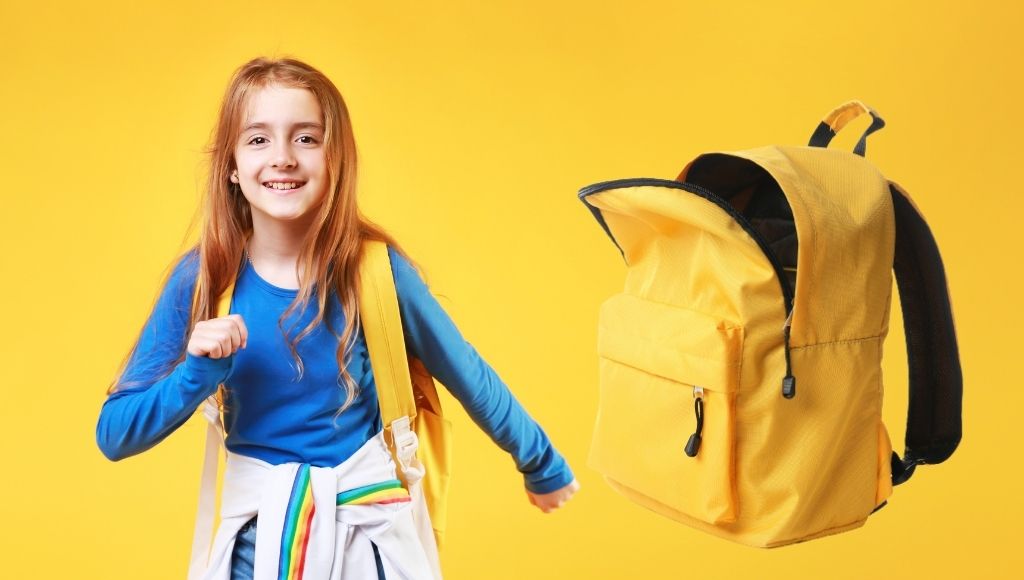 A schoolchild runnign with an empty backpack